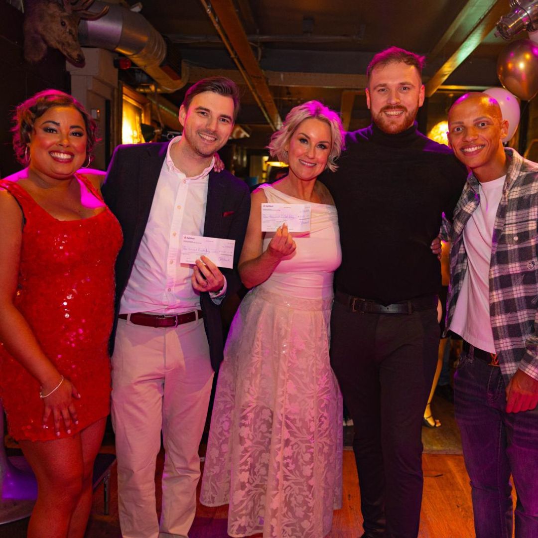 Generous donors presenting cheques. 